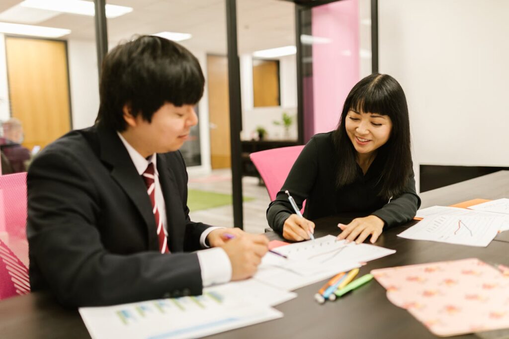 Two People Having a Meeting in the Office